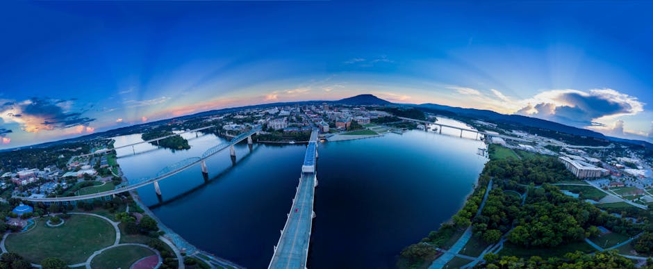 Stunning aerial view of Chattanooga, TN with bridges and river at sunset.